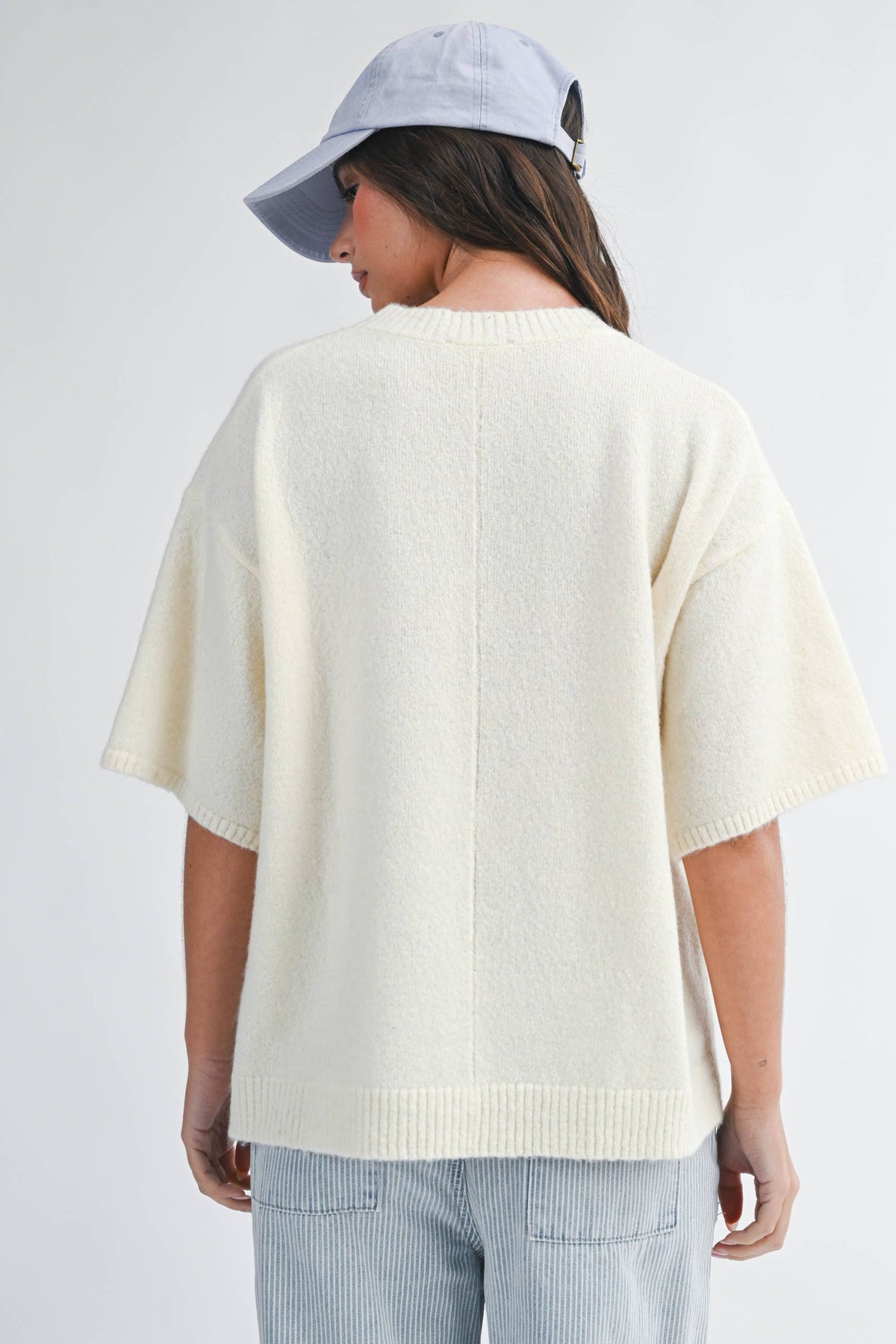 Soft knit top with ribbed details and relaxed fit.