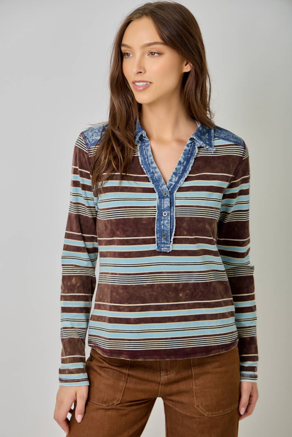 Women’s striped denim blouse with long sleeves and shirt collar.