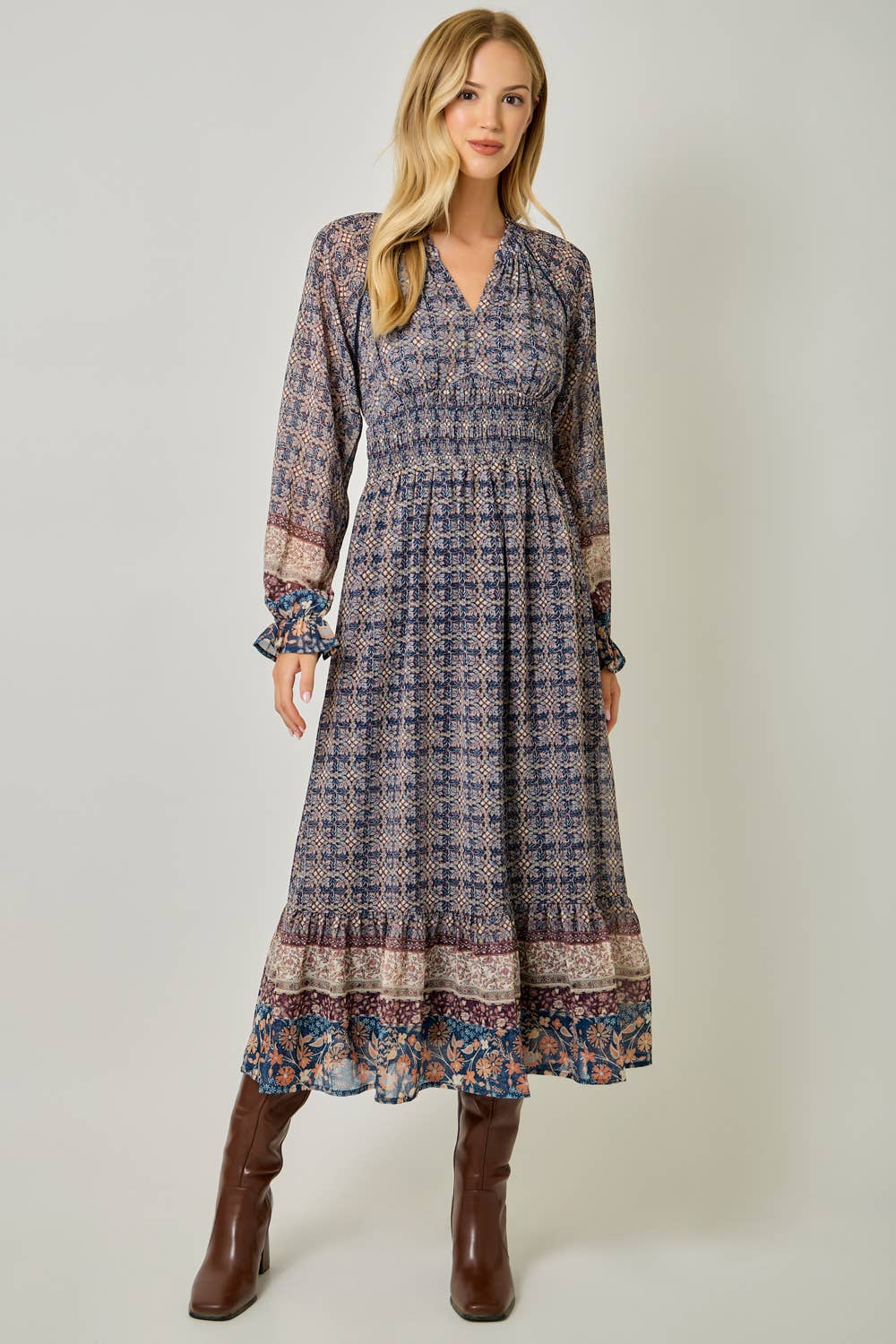 A feminine midi dress with ruffled details and a smocked waist.