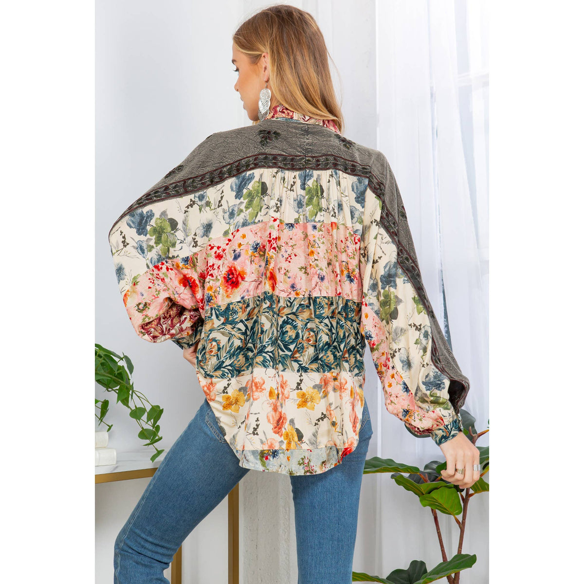 Elegant floral embroidered blouse for women with balloon sleeves and button details.