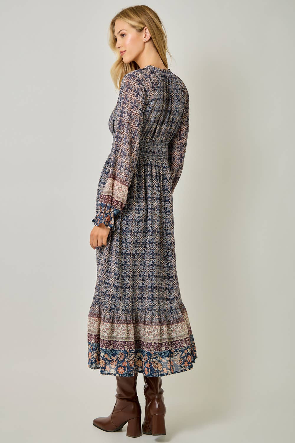 A feminine midi dress with ruffled details and a smocked waist.