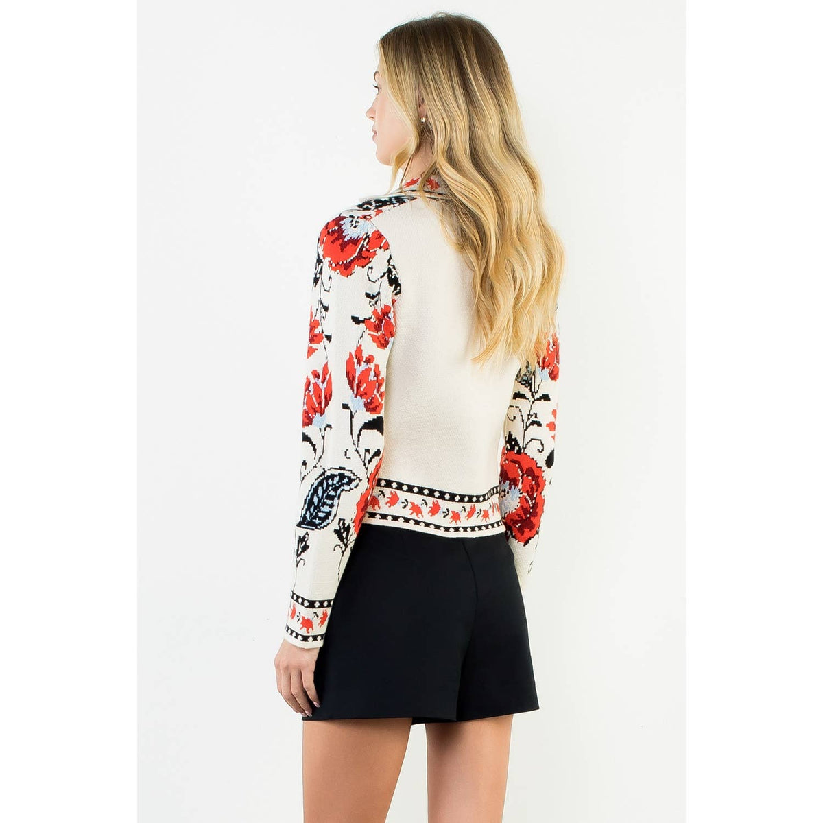 A stylish women's cropped jacket with knitted details and ribbed cuffs.