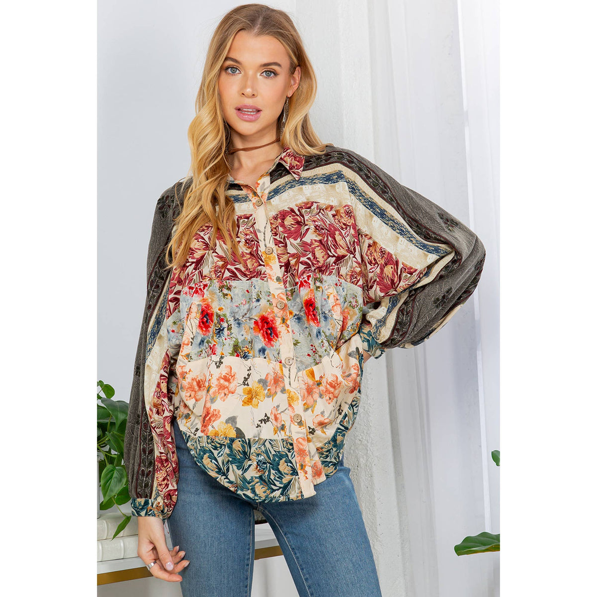 Elegant floral embroidered blouse for women with balloon sleeves and button details.