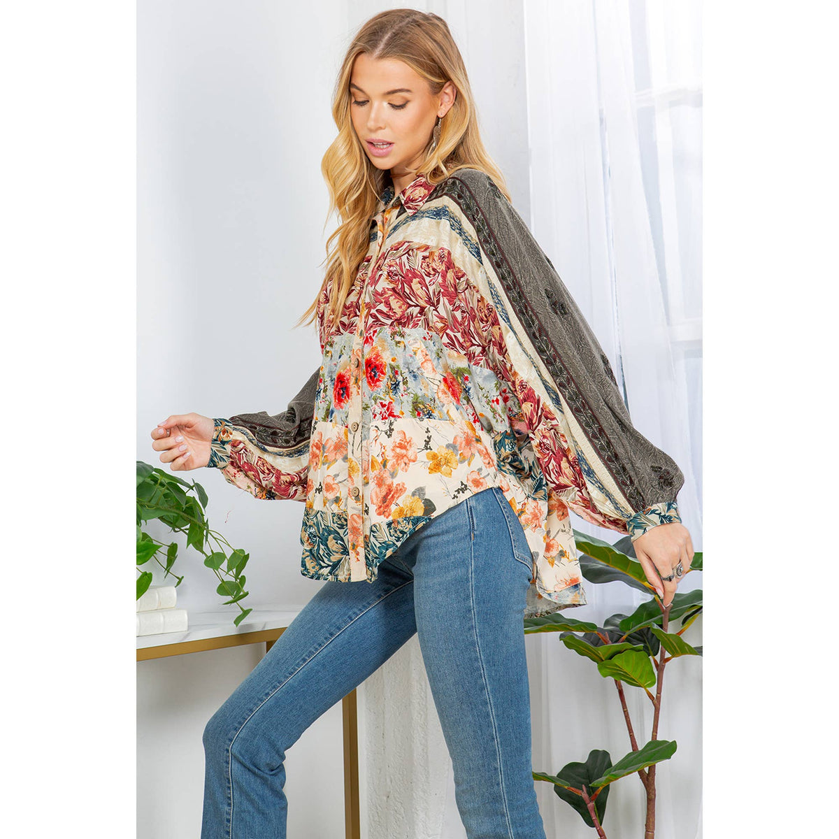 Elegant floral embroidered blouse for women with balloon sleeves and button details.