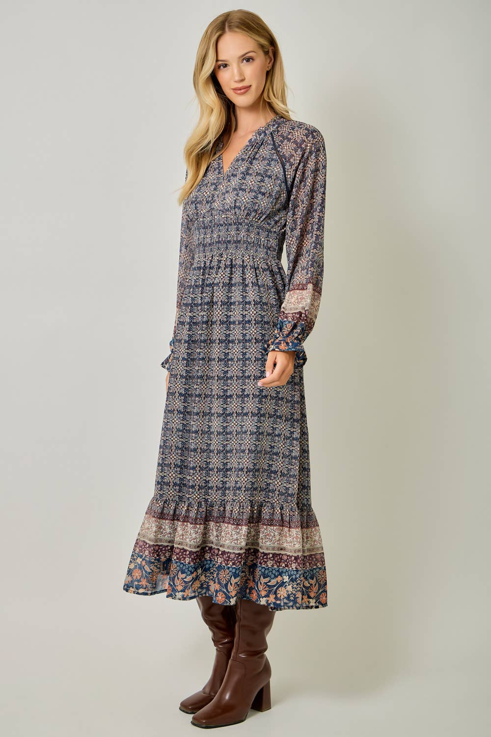 A feminine midi dress with ruffled details and a smocked waist.