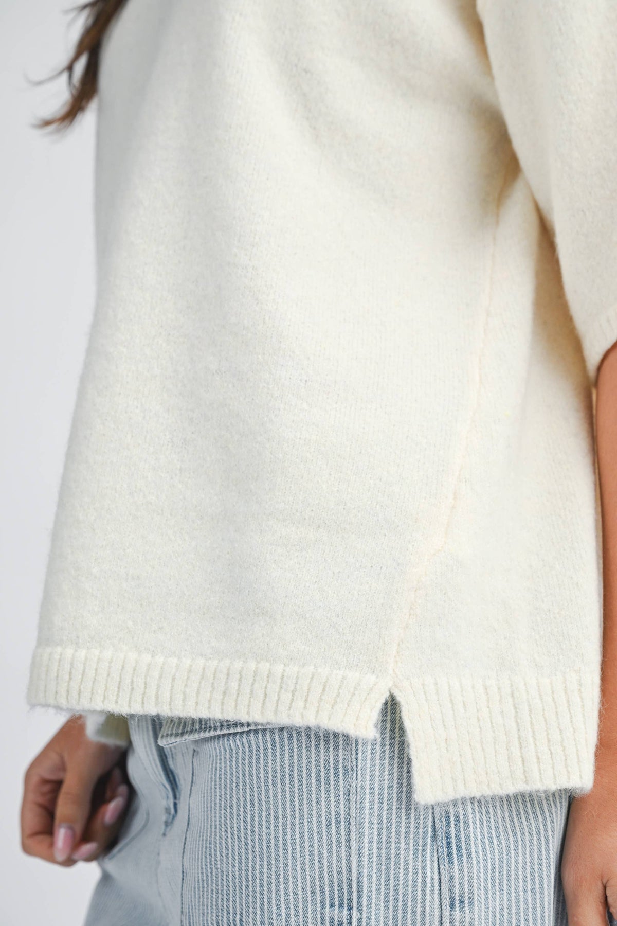 Soft knit top with ribbed details and relaxed fit.