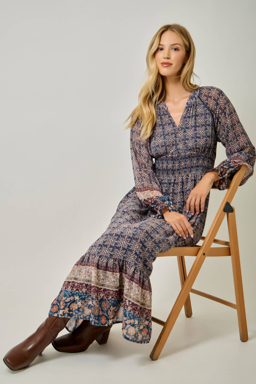 A feminine midi dress with ruffled details and a smocked waist.