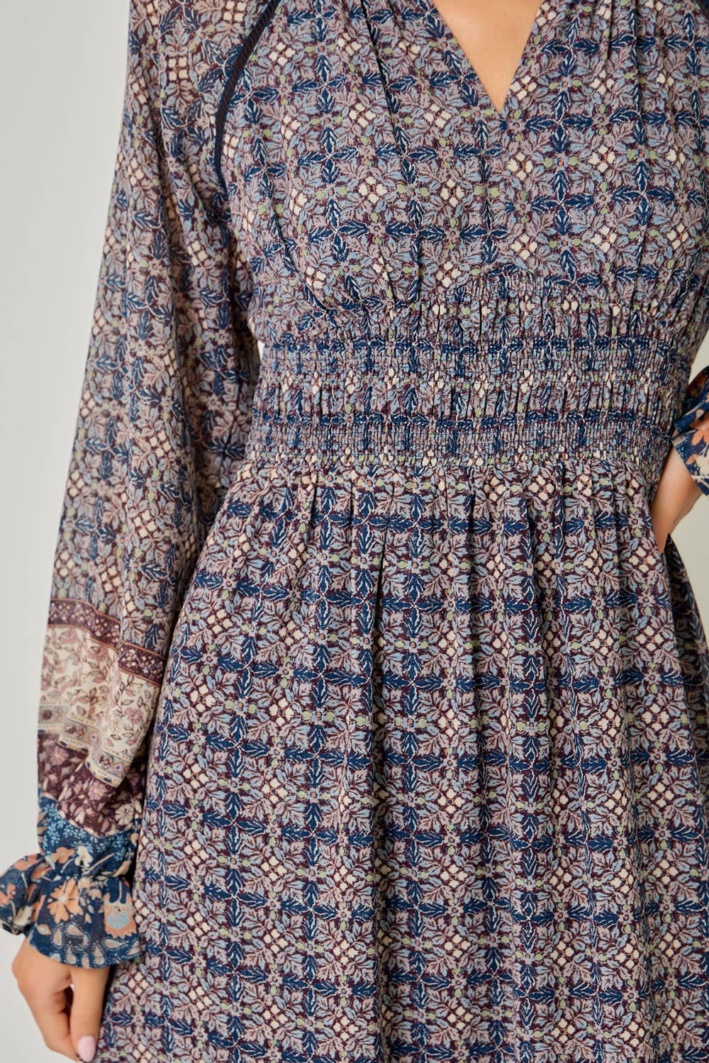 A feminine midi dress with ruffled details and a smocked waist.