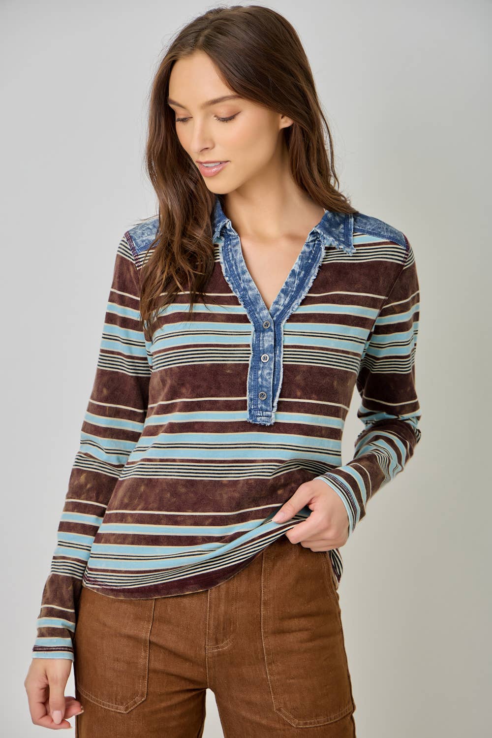 Women’s striped denim blouse with long sleeves and shirt collar.