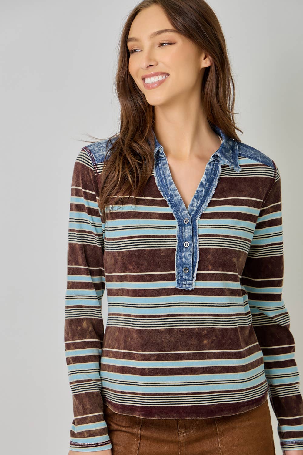 Women’s striped denim blouse with long sleeves and shirt collar.