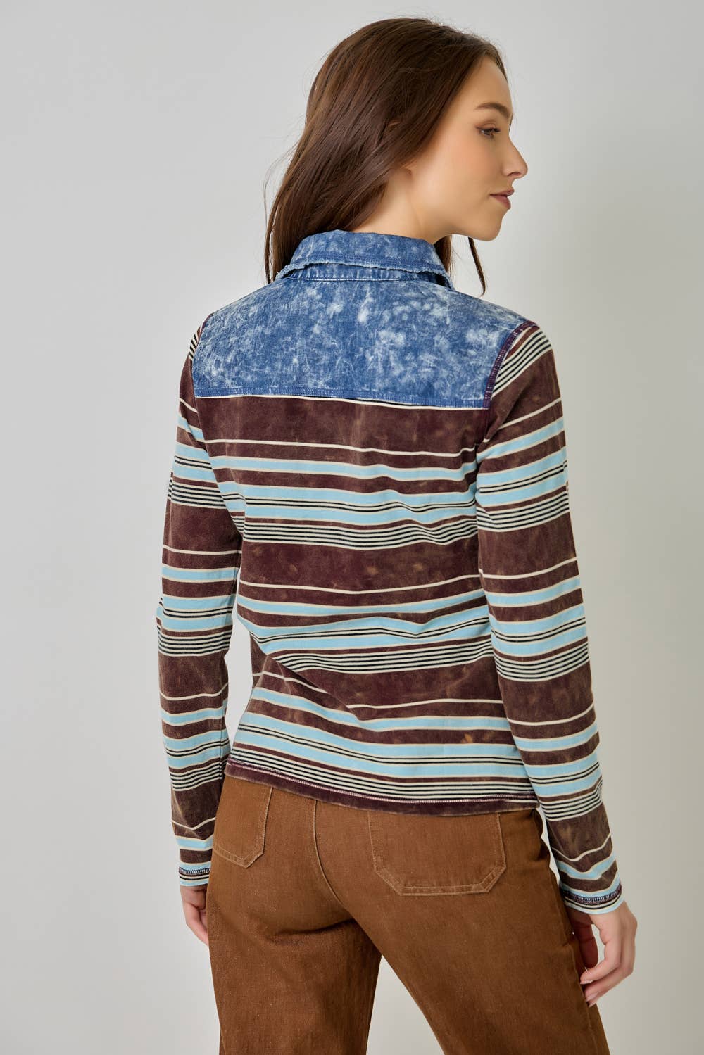 Women’s striped denim blouse with long sleeves and shirt collar.