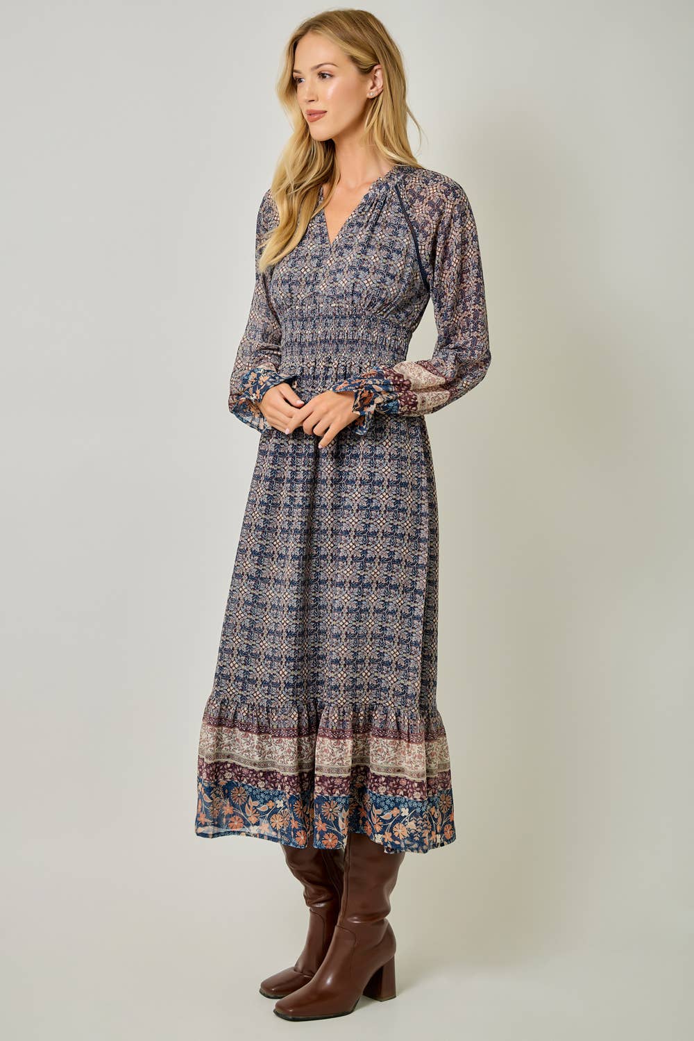 A feminine midi dress with ruffled details and a smocked waist.
