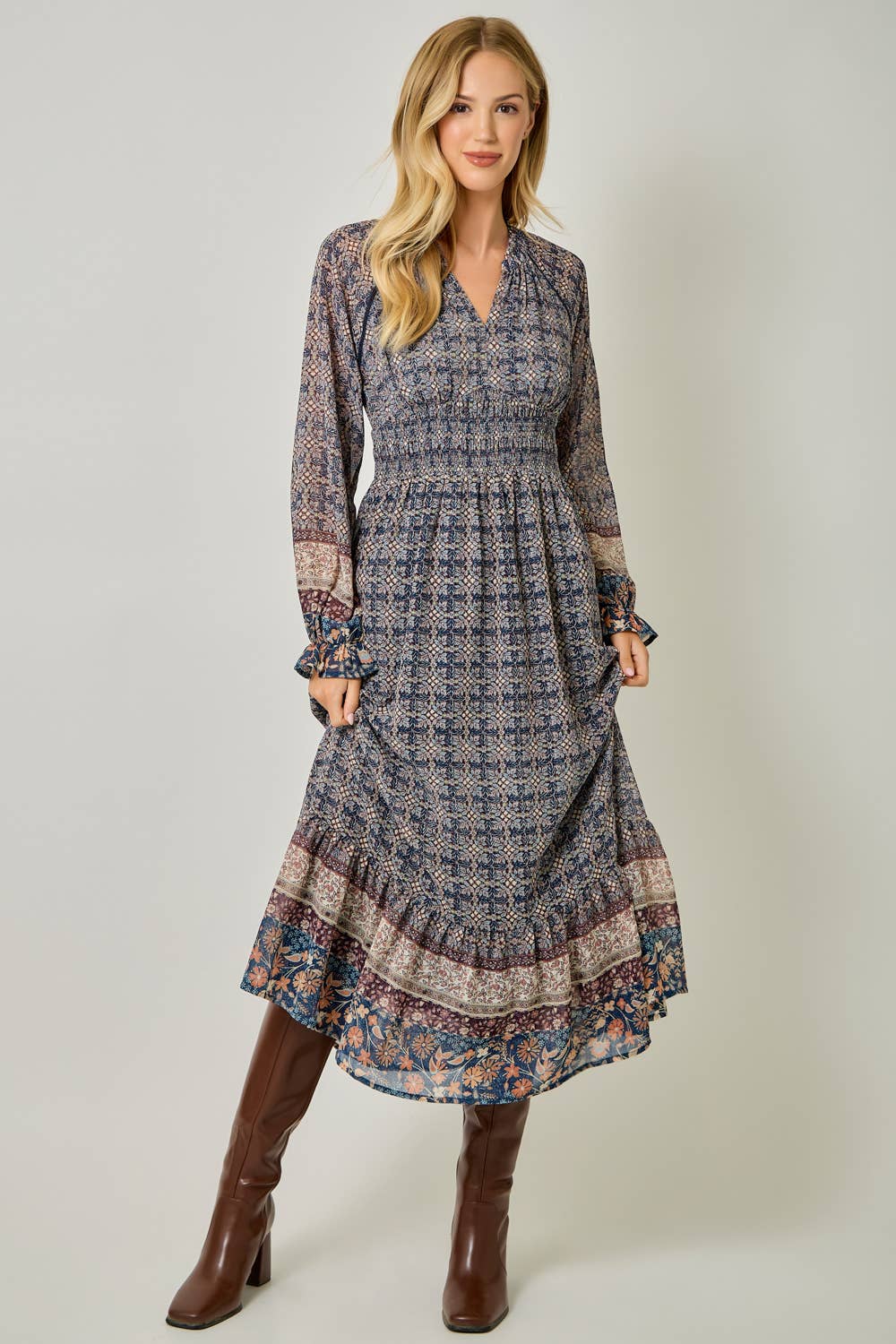 A feminine midi dress with ruffled details and a smocked waist.
