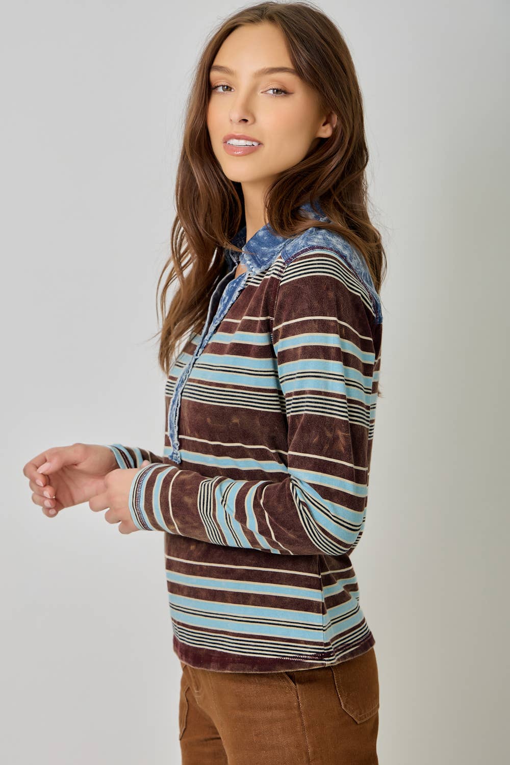 Women’s striped denim blouse with long sleeves and shirt collar.