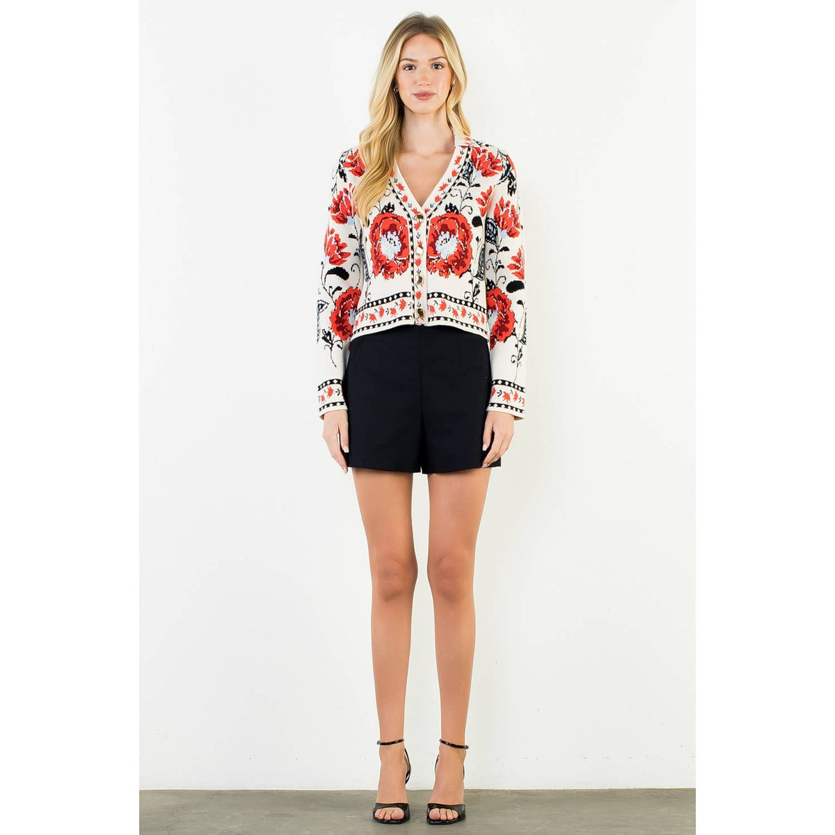 A stylish women's cropped jacket with knitted details and ribbed cuffs.