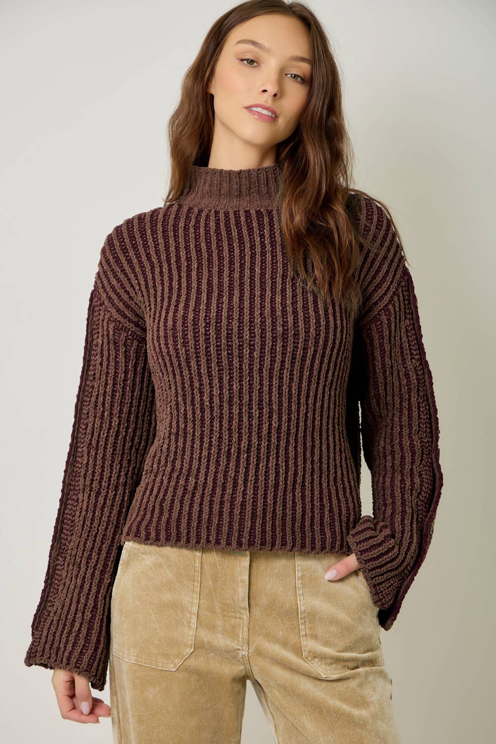 A stylish velvet sweater with color-blocking and decorative buttons.