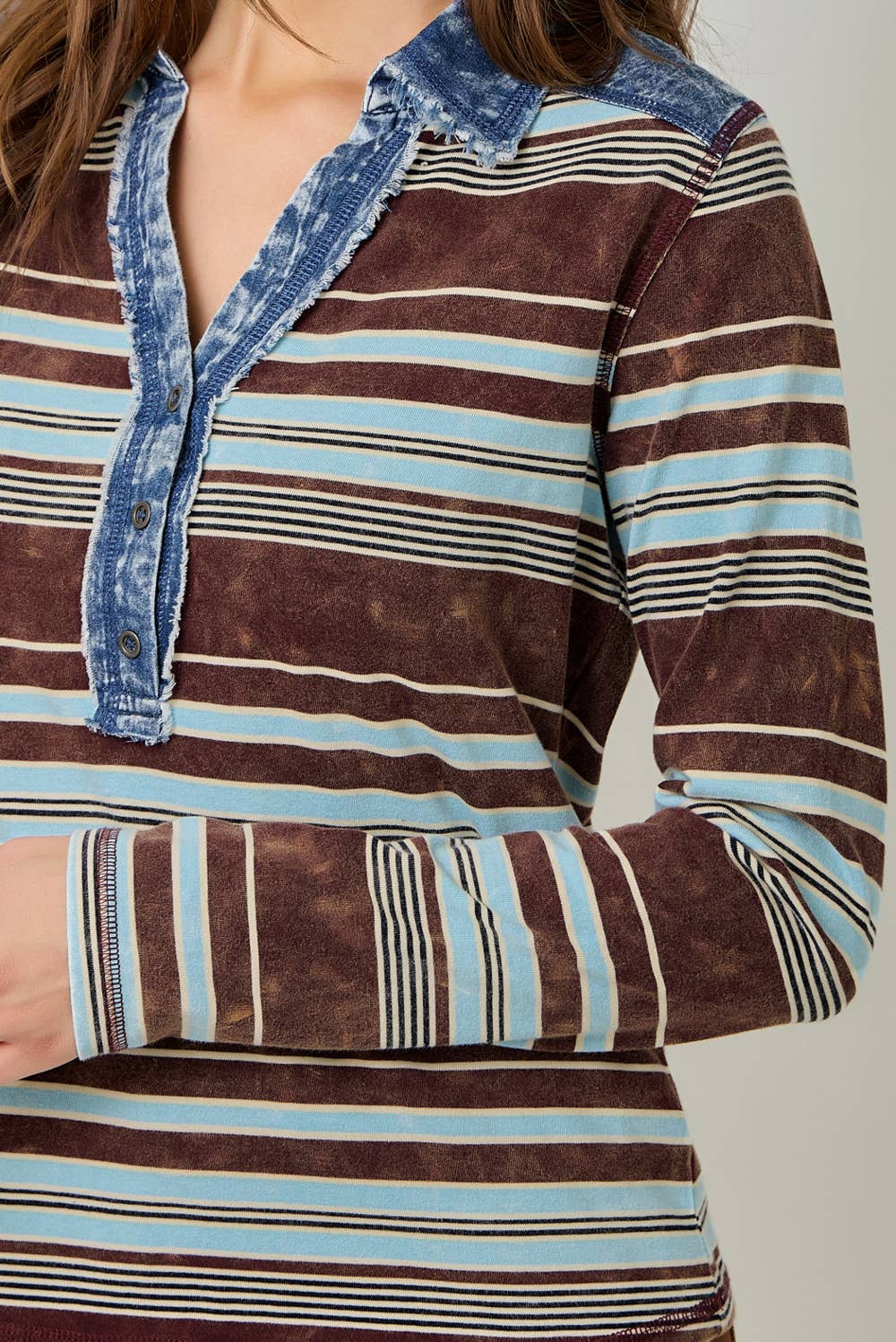 Women’s striped denim blouse with long sleeves and shirt collar.